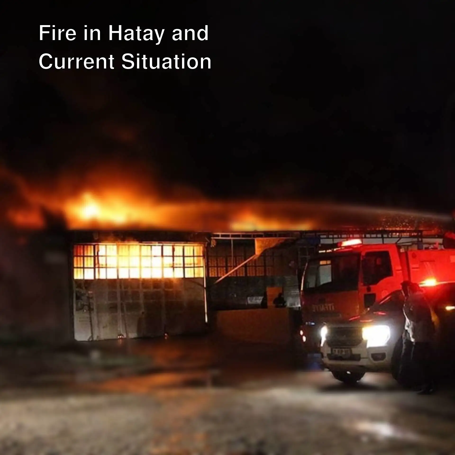 A fire on a building at night.