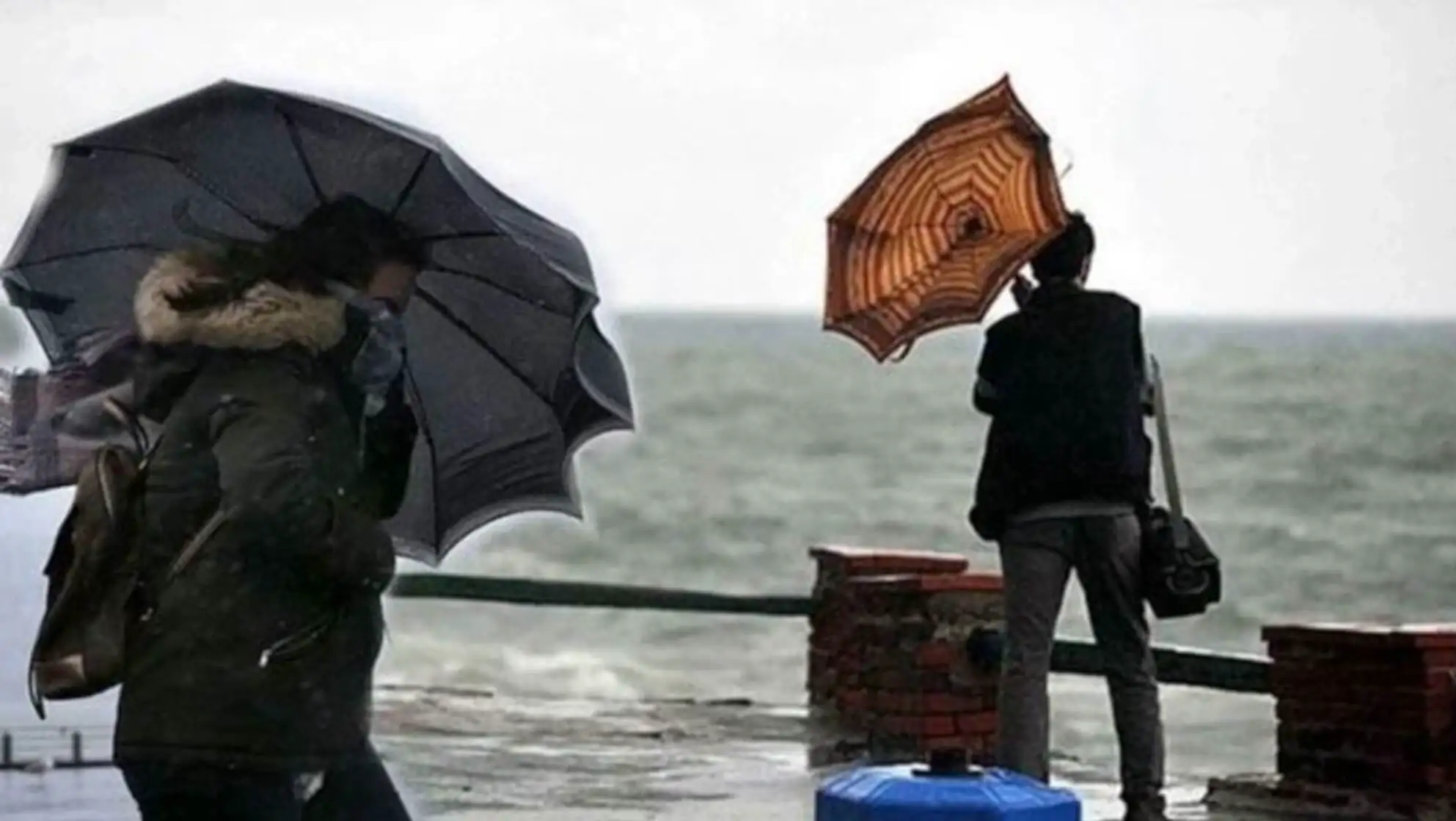Two people holding umbrellas on a rainy day. Two people holding umbrellas on a rainy day.