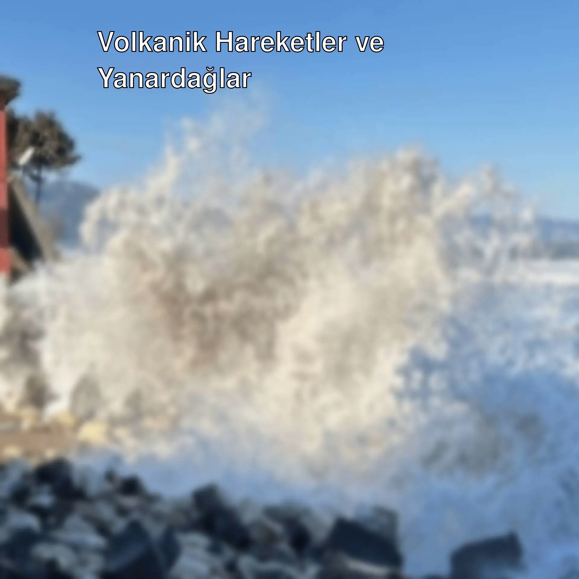 Dalgaların kayalara çarptığı bir plaj görüntüsü.