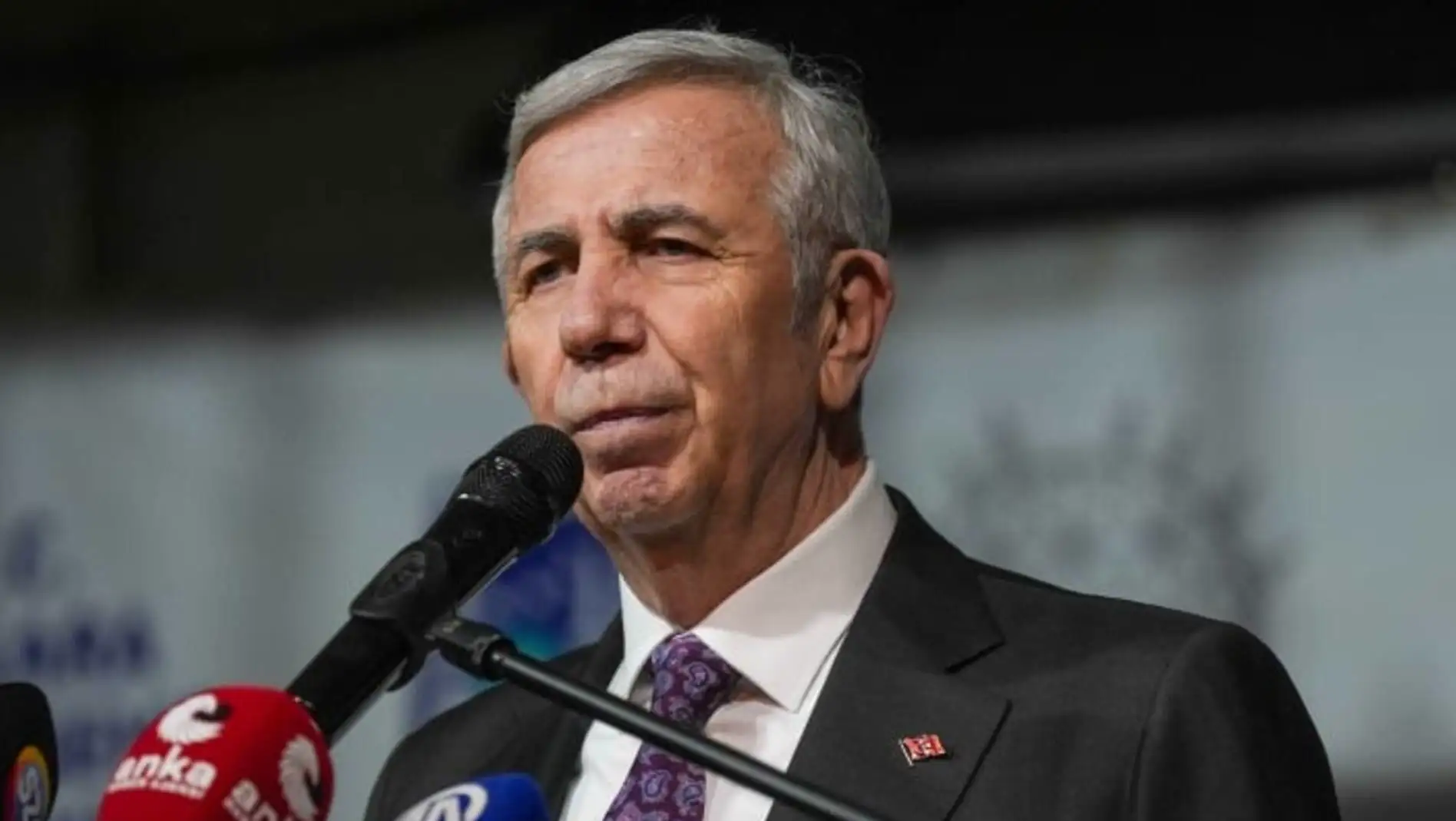 Mansur Yavaş speaking into a microphone. Mansur Yavaş speaking into a microphone.