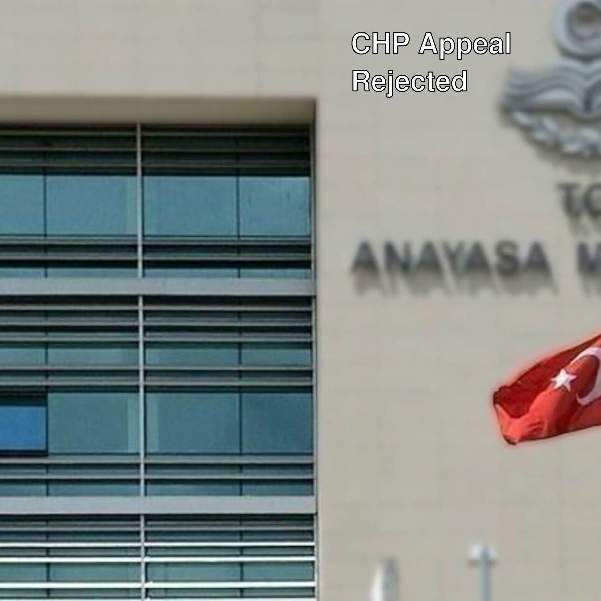 A flag flying in front of a building A flag flying in front of a building