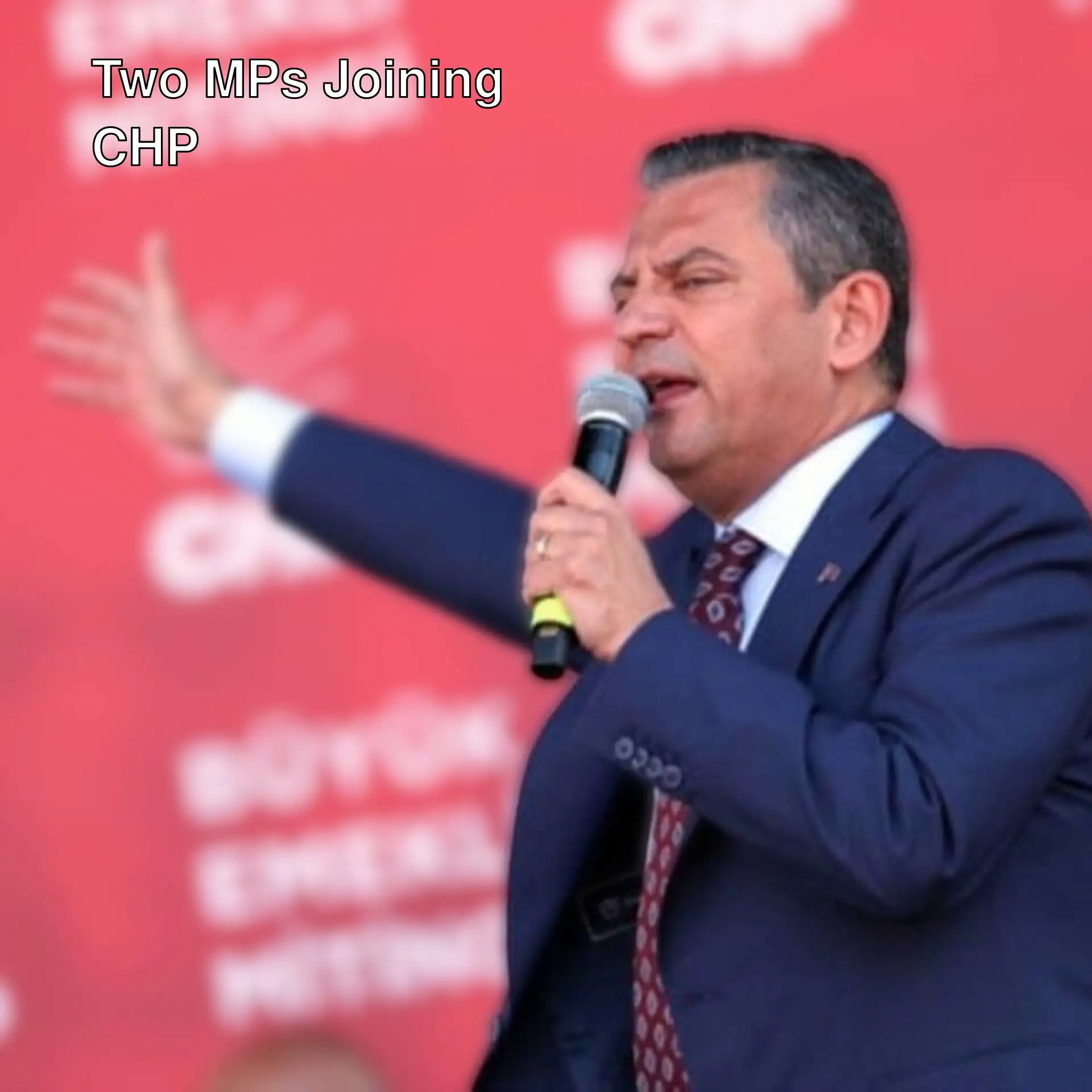 A man holding a microphone. A man holding a microphone.