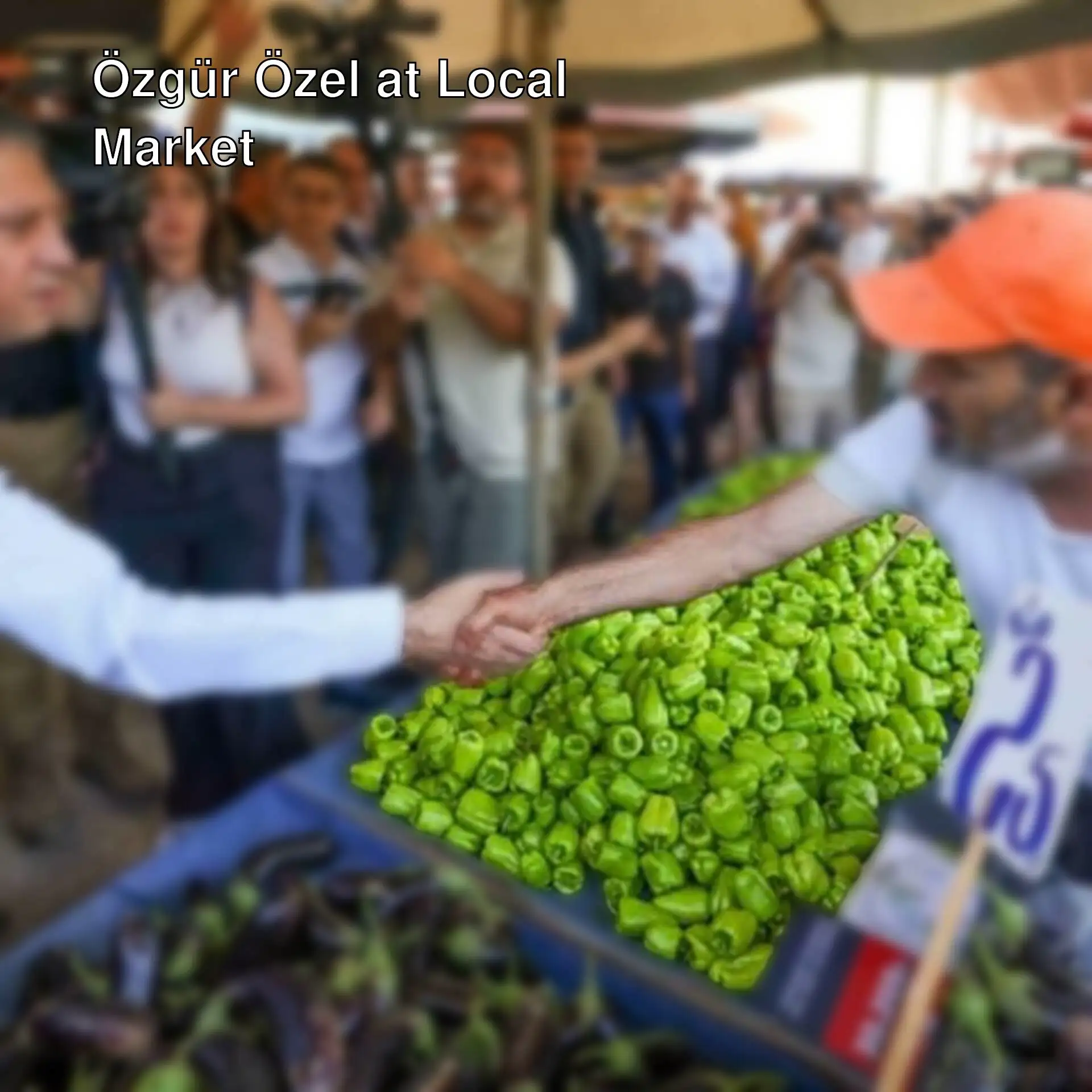 Özgür Özel shakes hands with a market vendor.