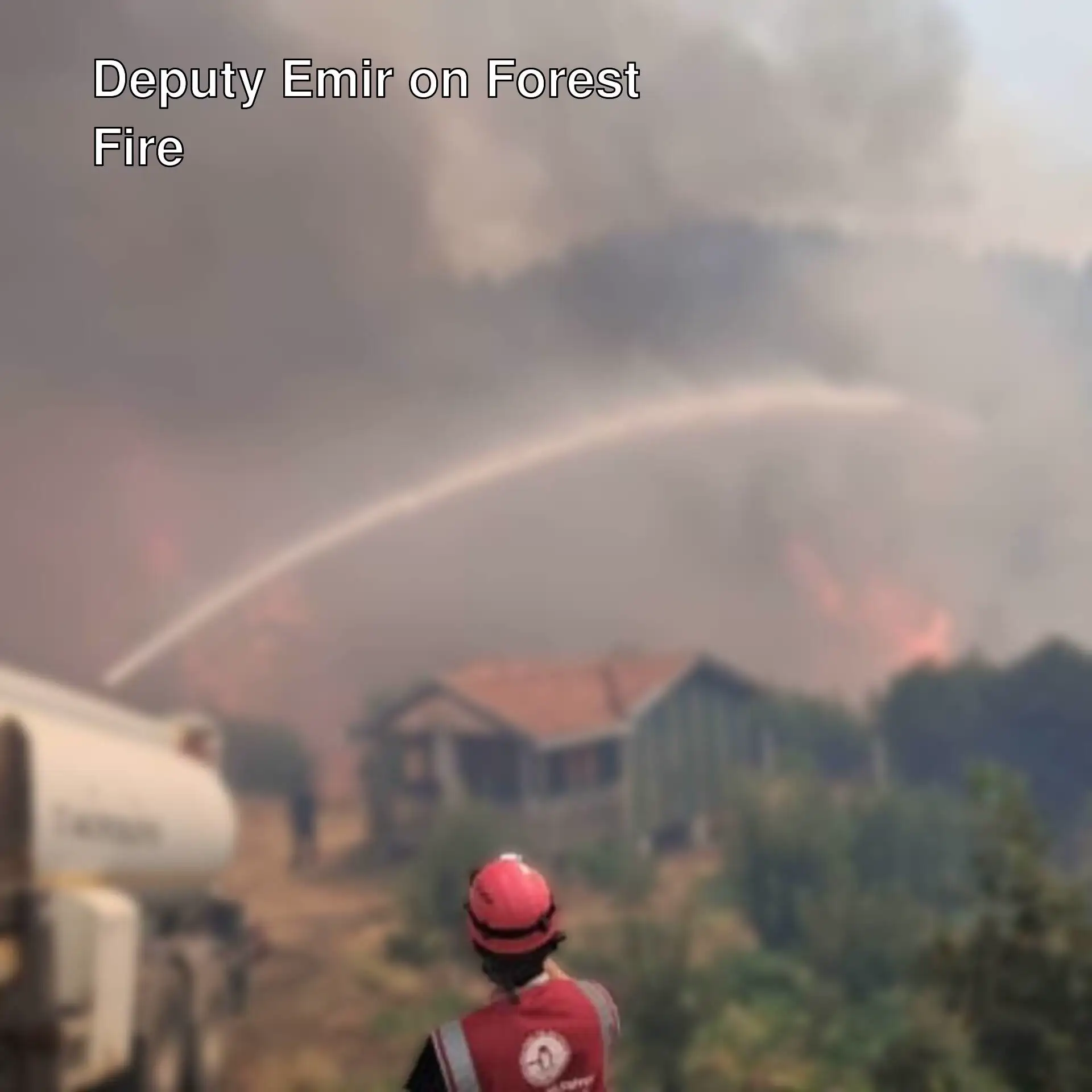 A firefighter spraying water on a fire.