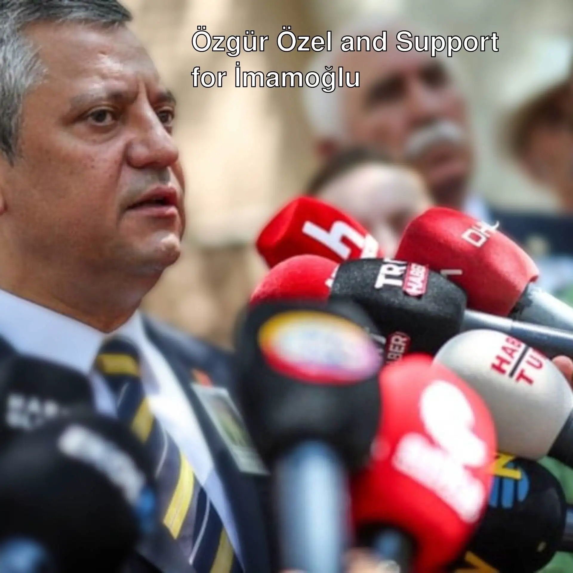 Özgür Özel holding a microphone. Özgür Özel holding a microphone.
