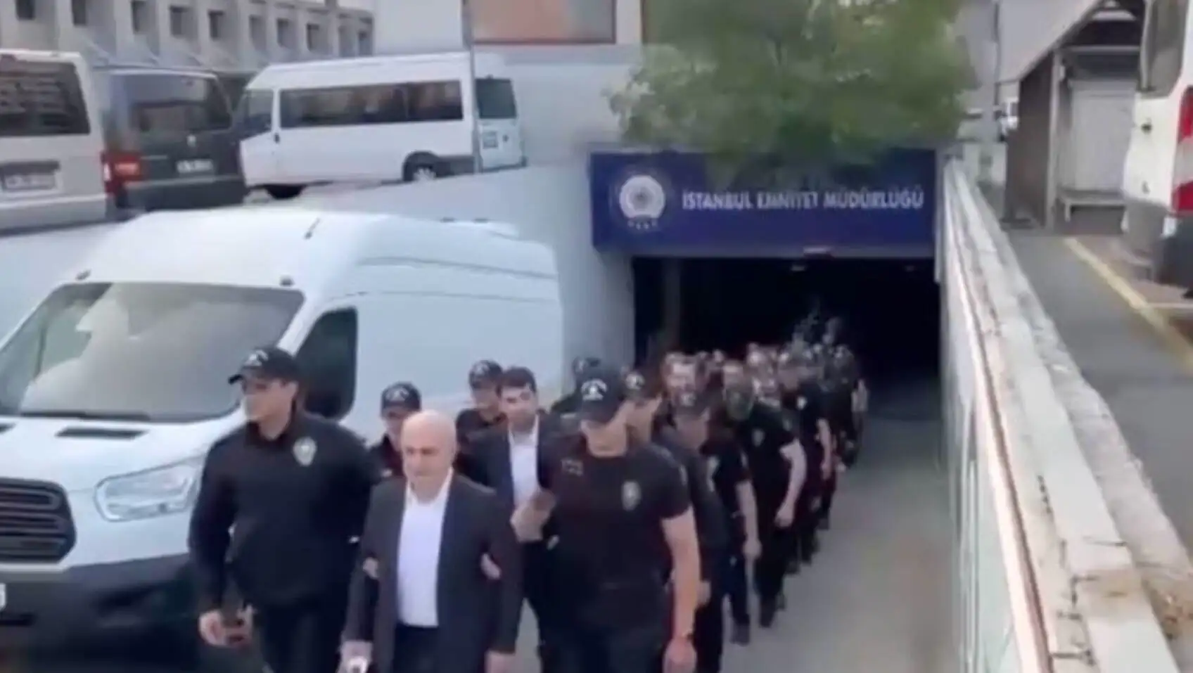 Police officers are being escorted to the courthouse during the arrest procedures.