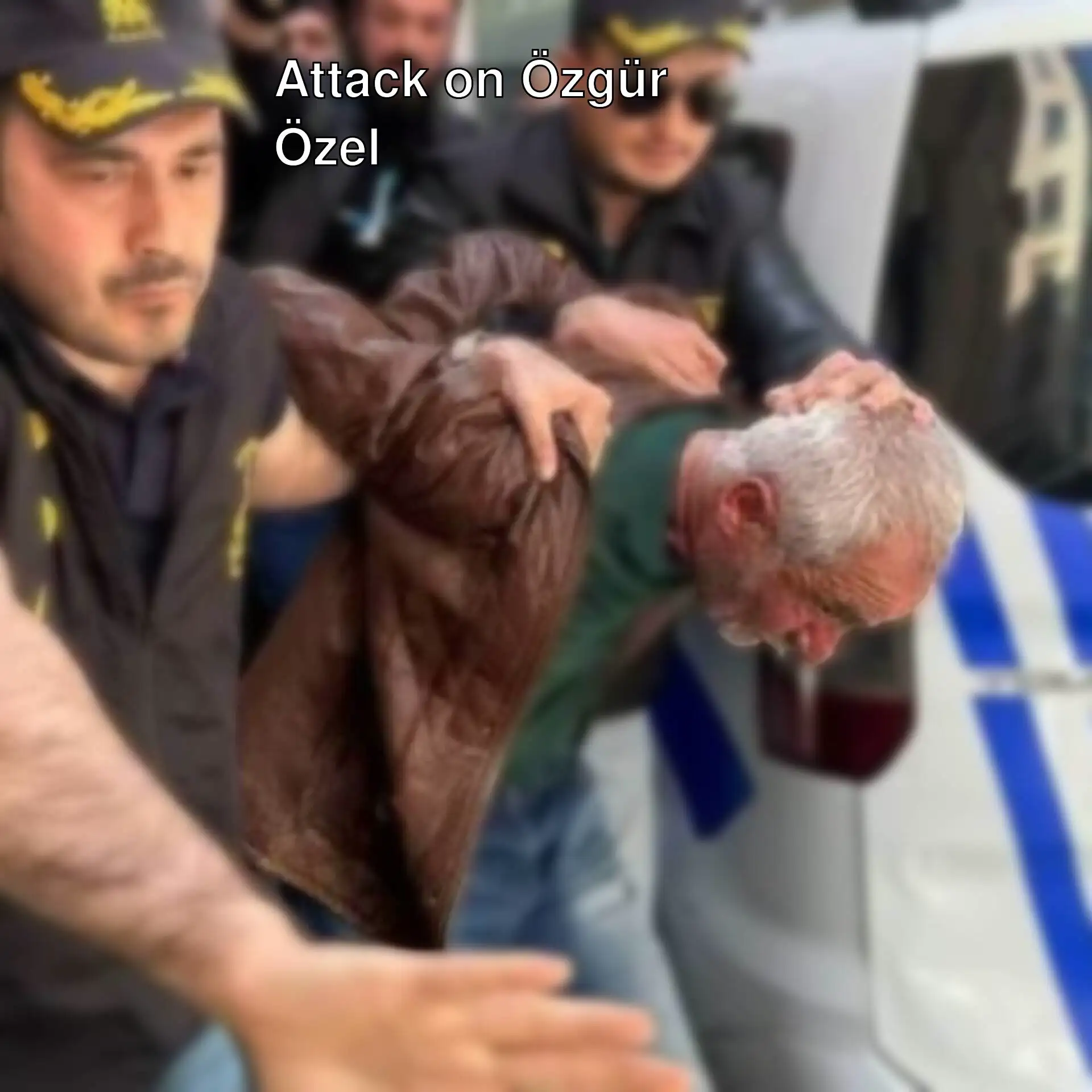 A man being carried by a police officer after the attack on Özgür Özel. A man being carried by a police officer after the attack on Özgür Özel.