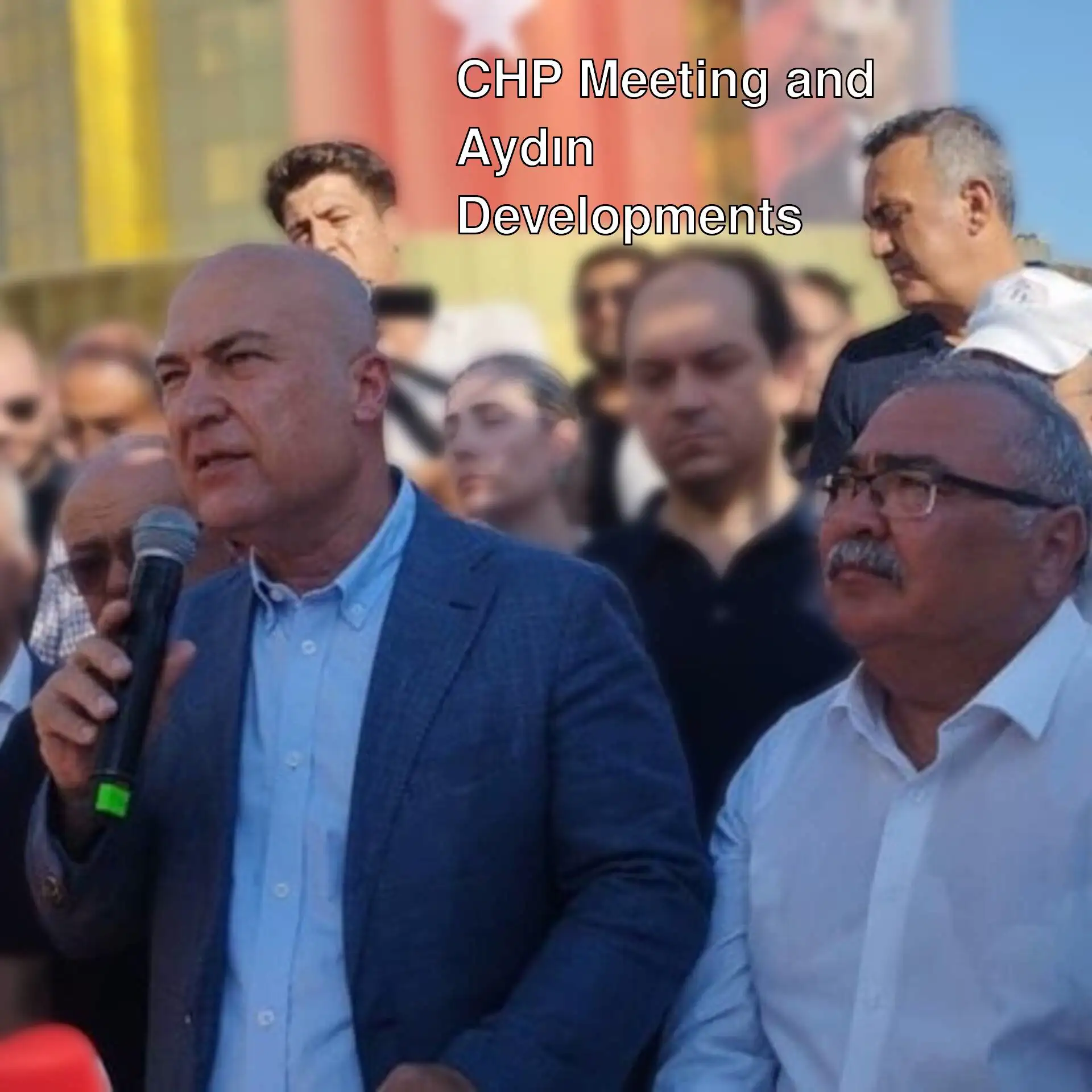 A man speaking into a microphone in front of a crowd of people. A man speaking into a microphone in front of a crowd of people.