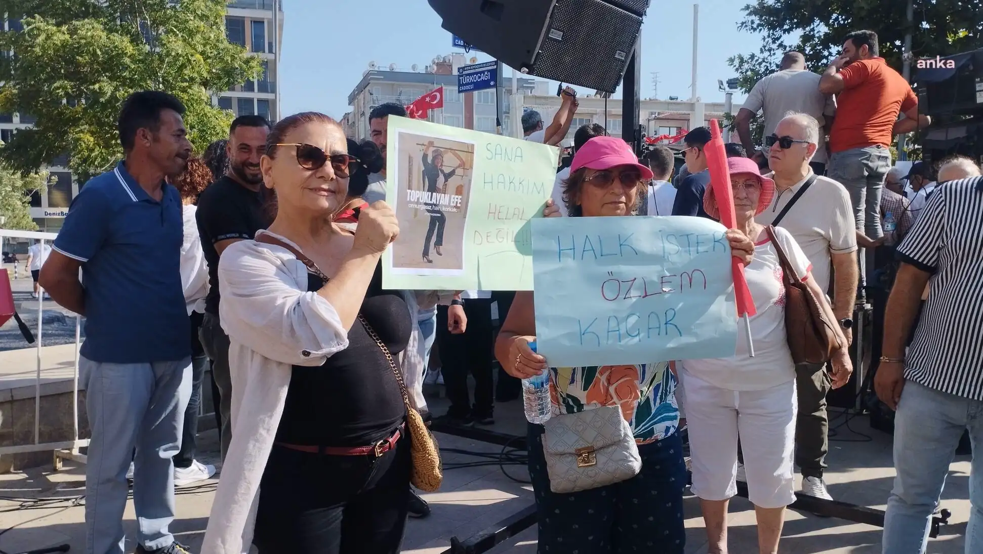 A group of people holding signs. A group of people holding signs.