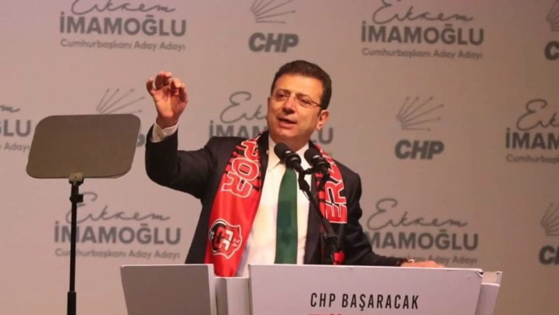 Ekrem İmamoğlu speaking at a podium.