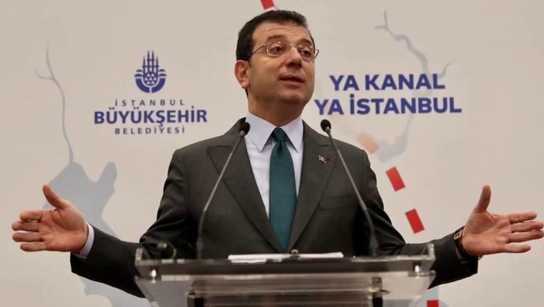 Ekrem İmamoğlu speaking at a podium. Ekrem İmamoğlu speaking at a podium.