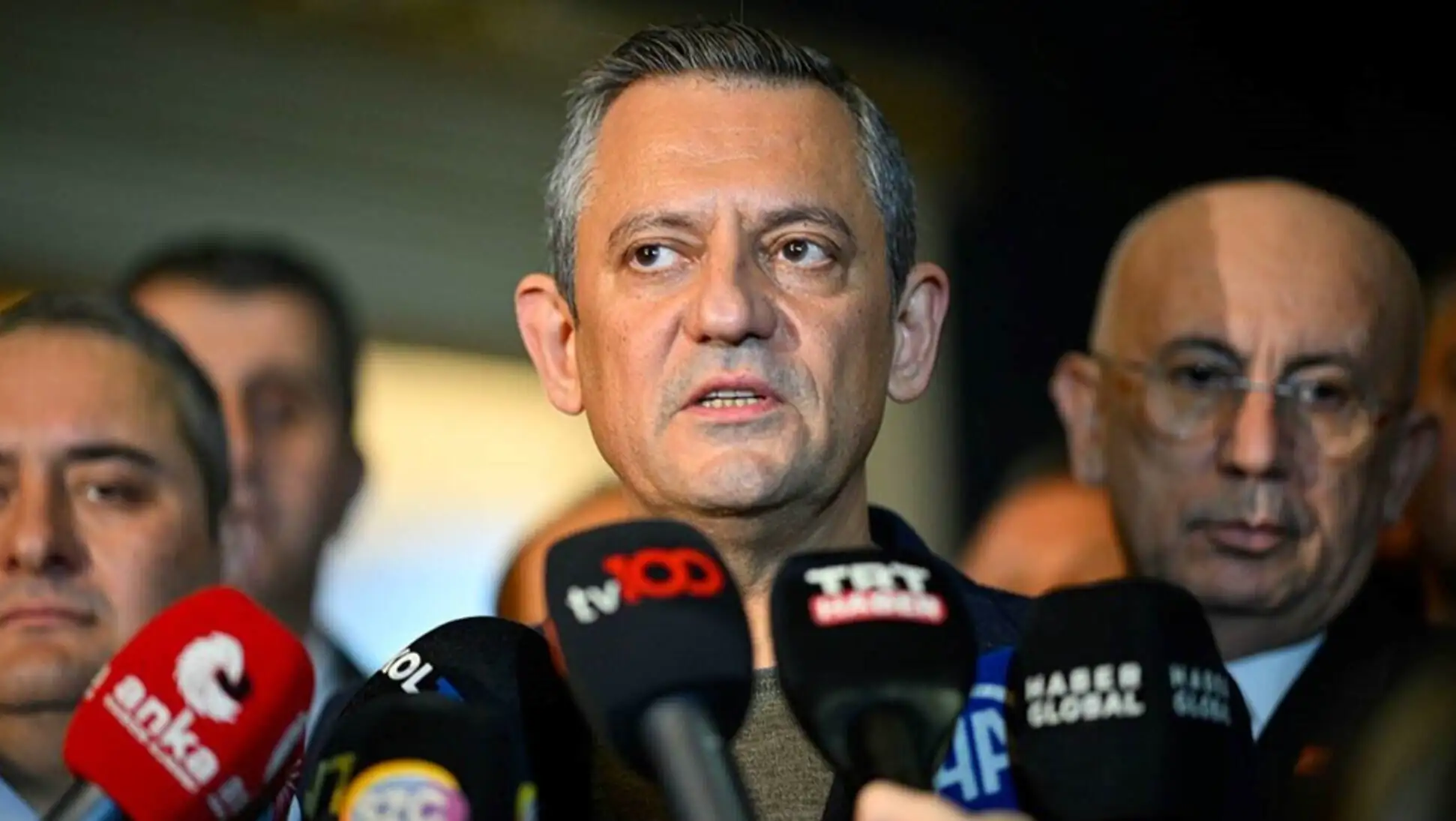 Özgür Özel speaking with a microphone.