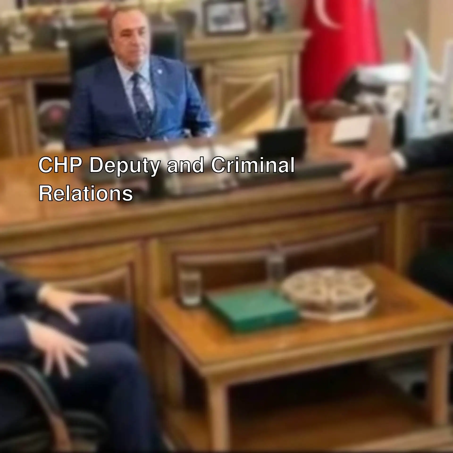 A group of men sitting at a desk. A group of men sitting at a desk.