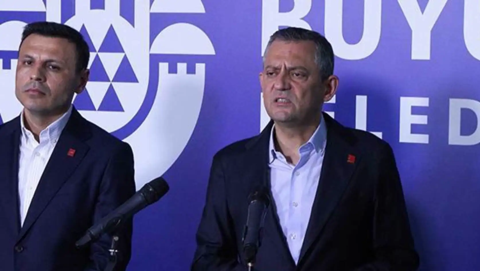 A man standing at a podium with microphones. A man standing at a podium with microphones.
