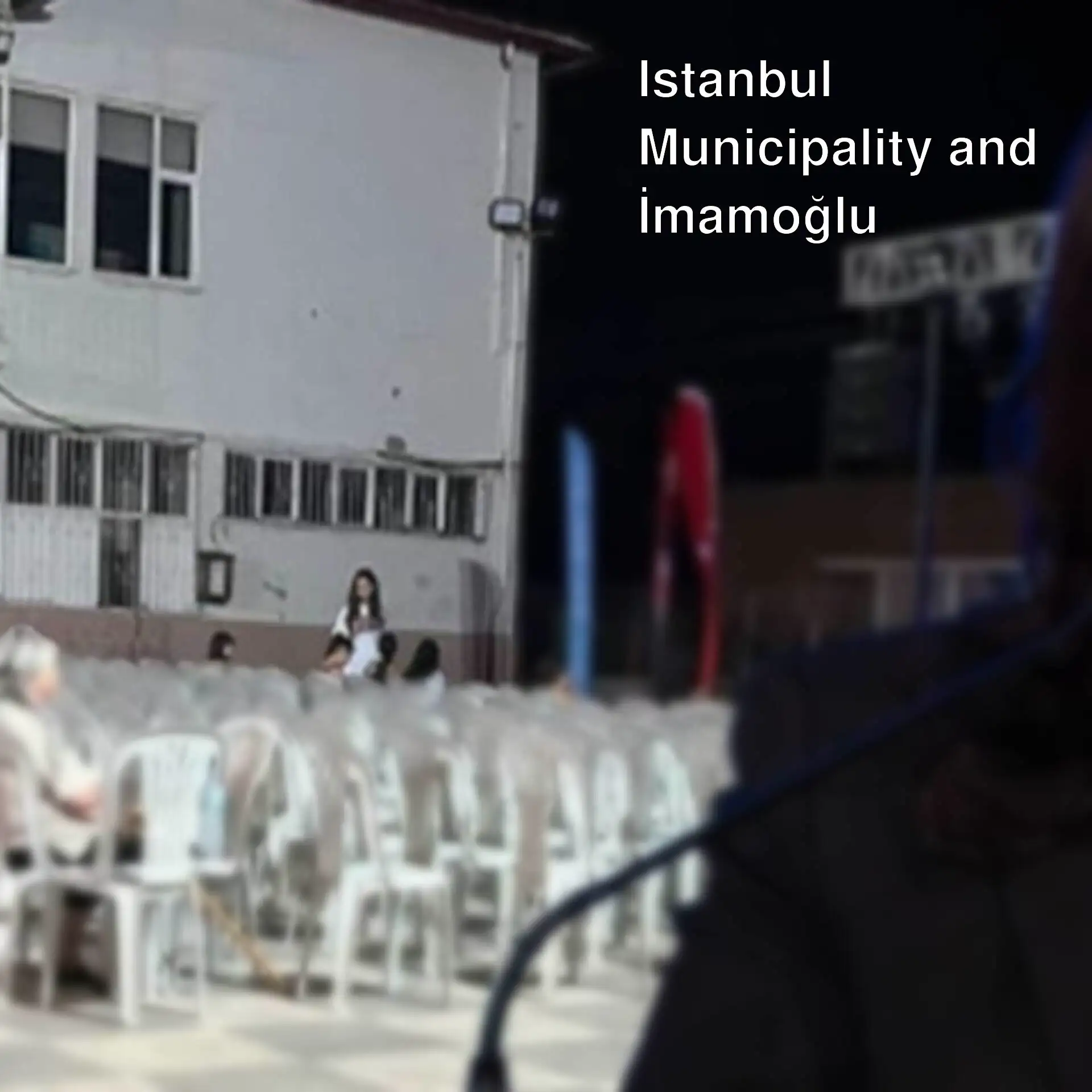 Özlem Çerçioğlu standing in front of a microphone. Özlem Çerçioğlu standing in front of a microphone.