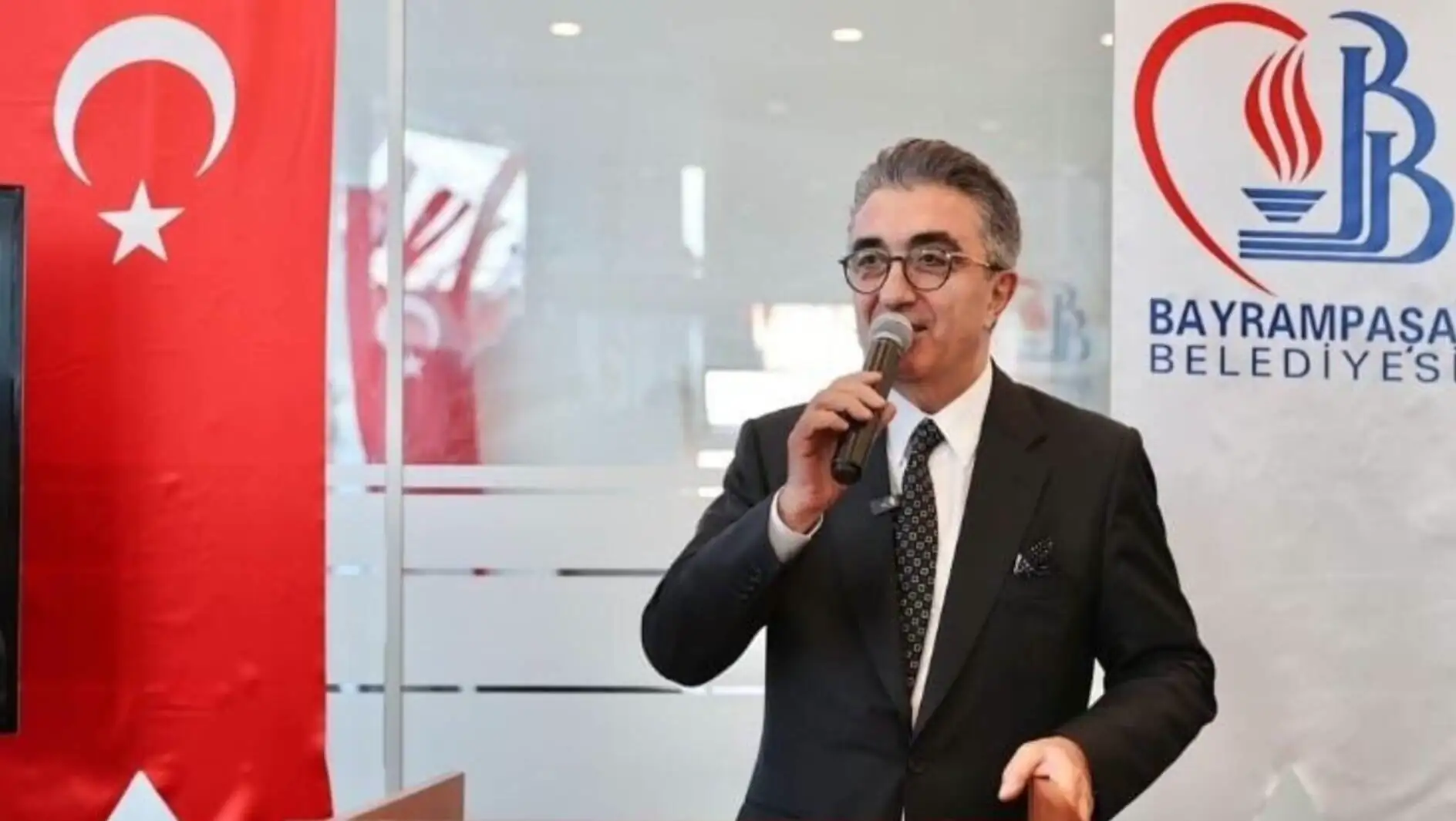 Bayrampaşa Mayor Hasan Mutlu speaking at a press conference.
