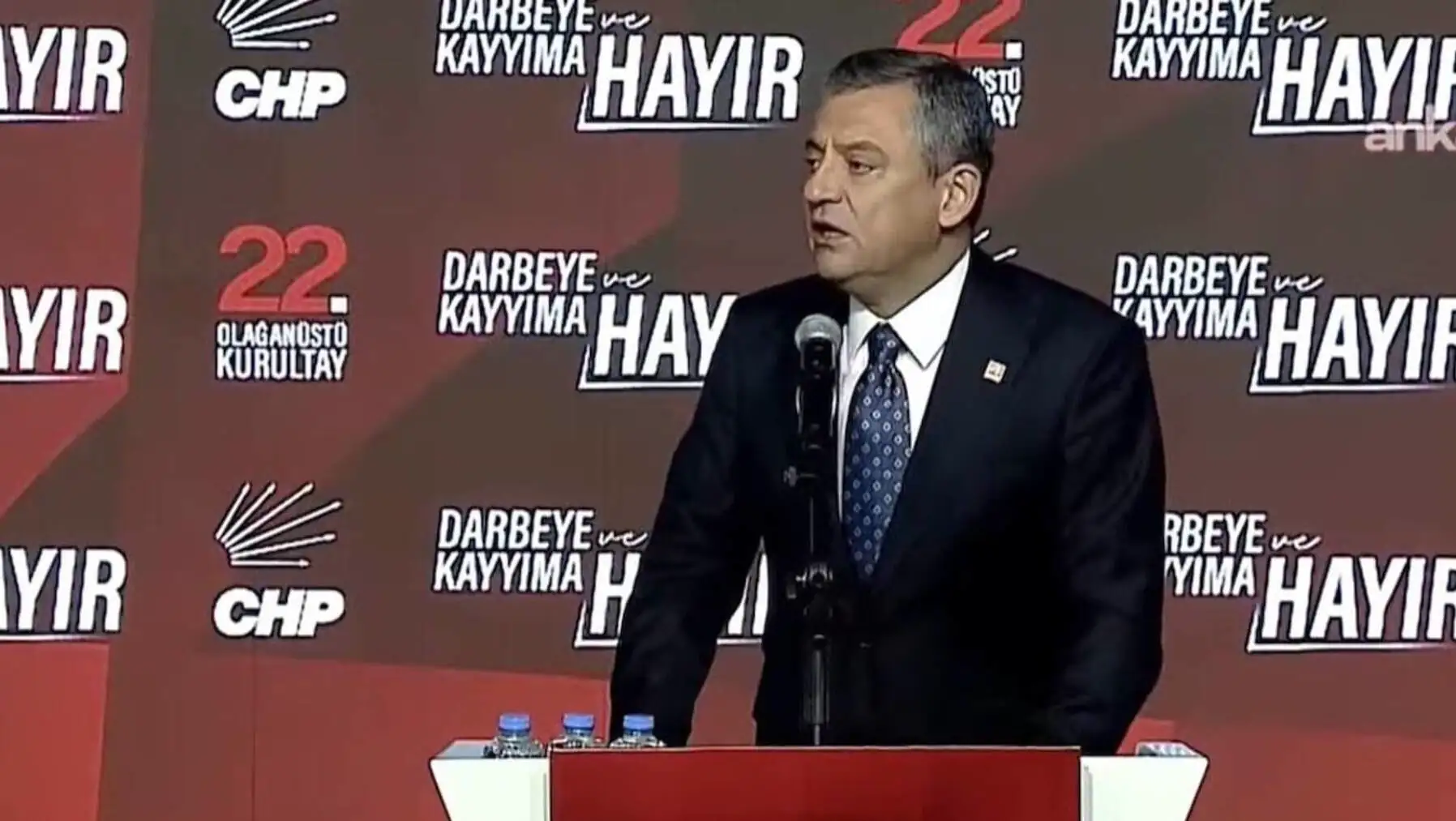 A man standing at a podium. A man standing at a podium.