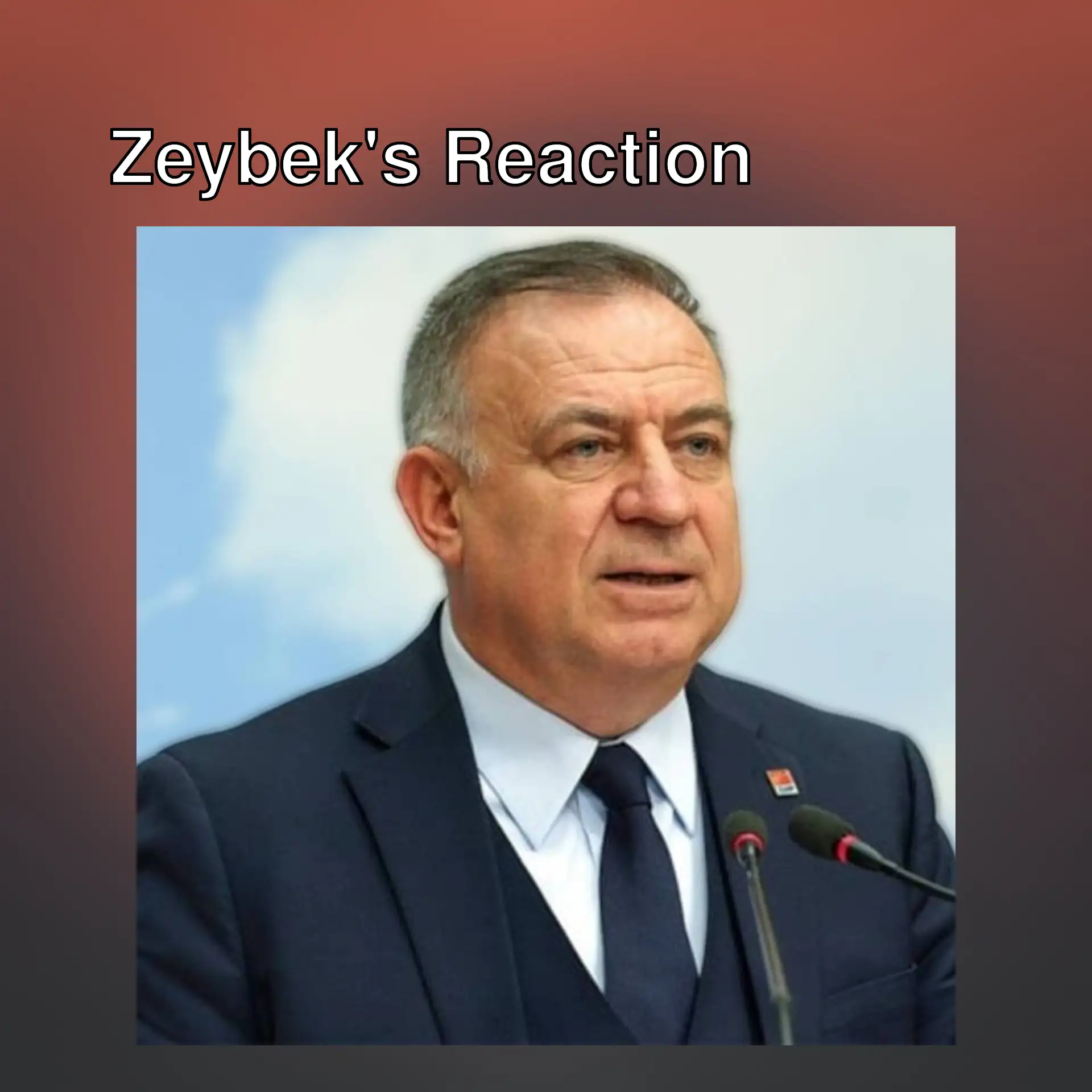 Gökan Zeybek speaking at a press conference.