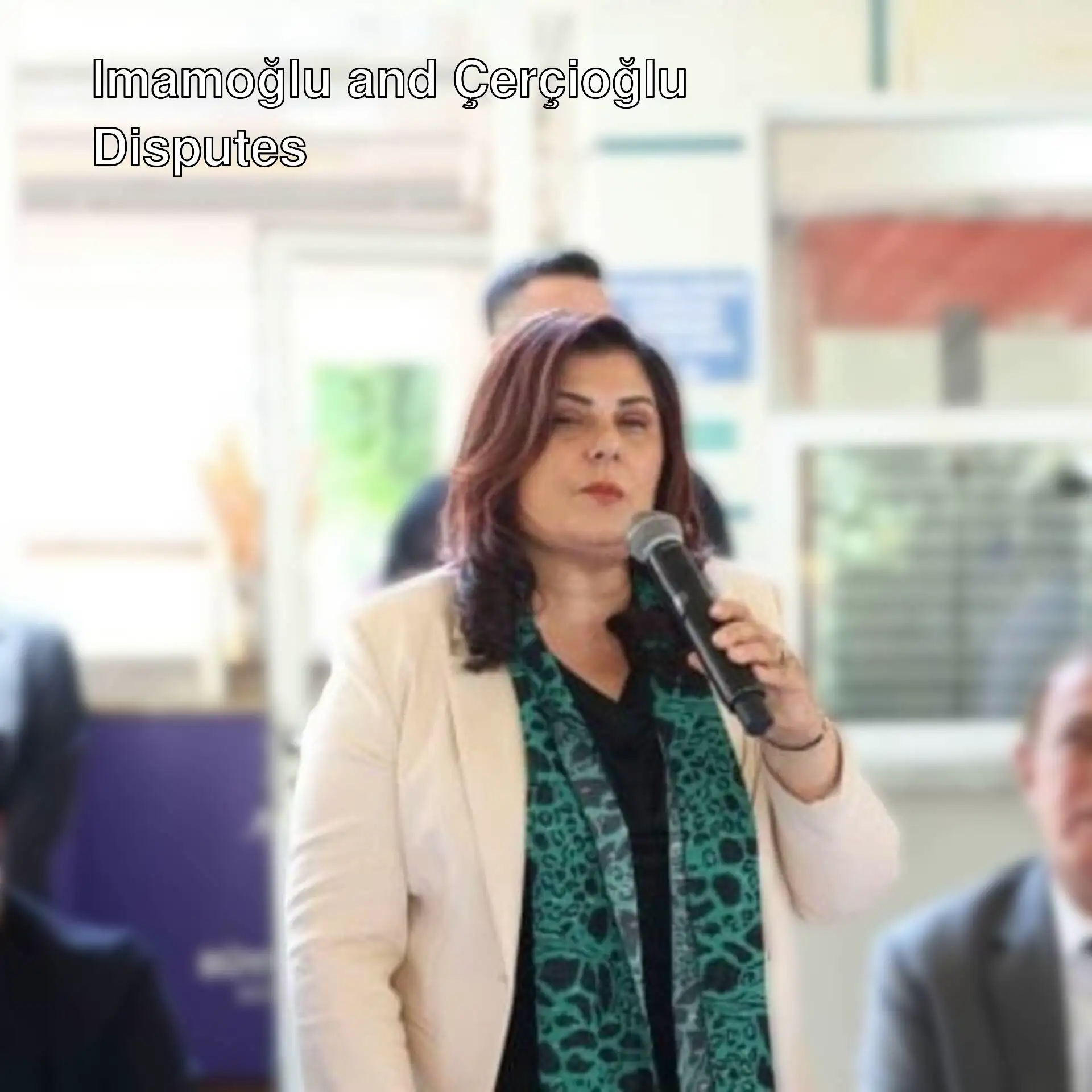 Özlem Çerçioğlu speaking into a microphone.