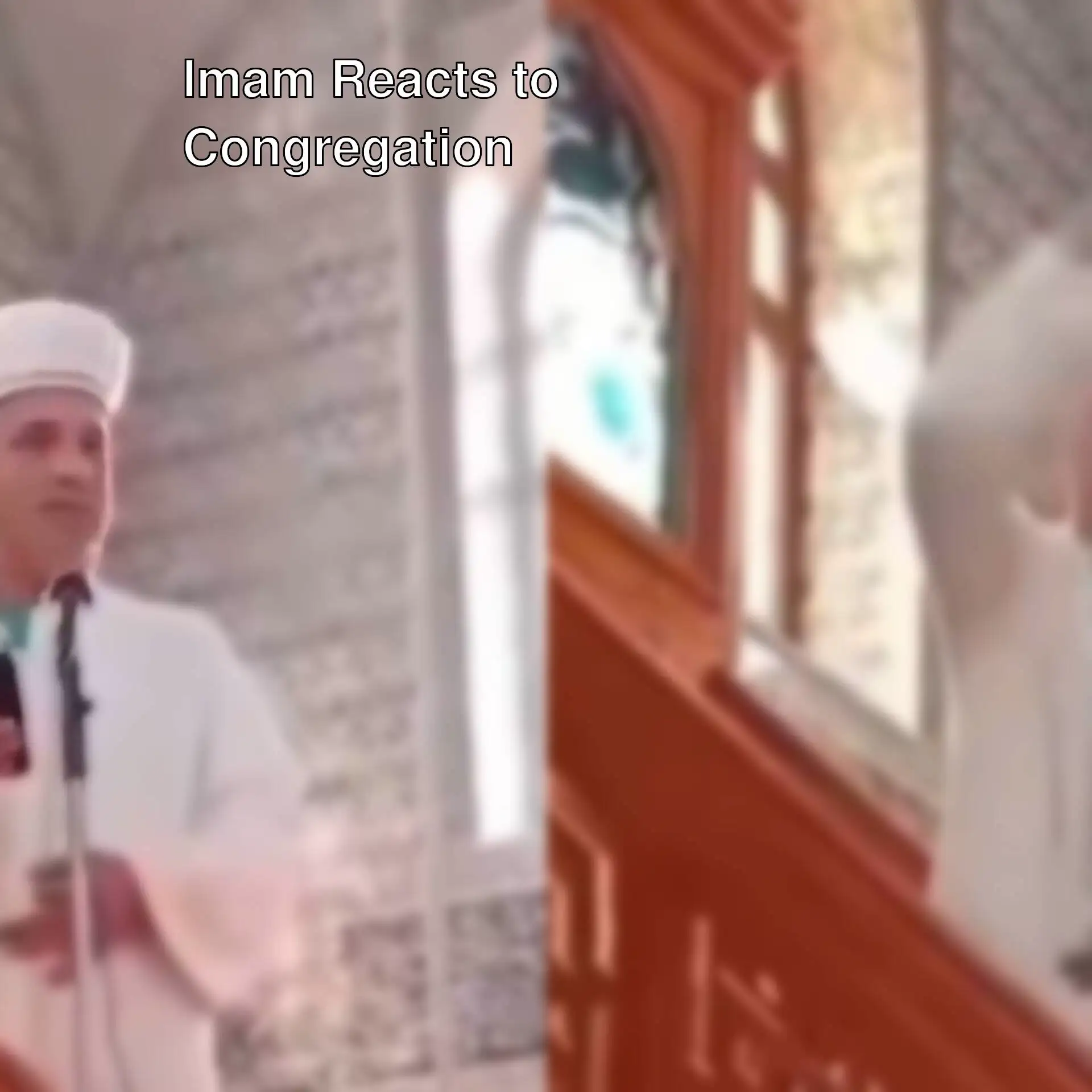 A man in a white robe and a white hat standing on a staircase.