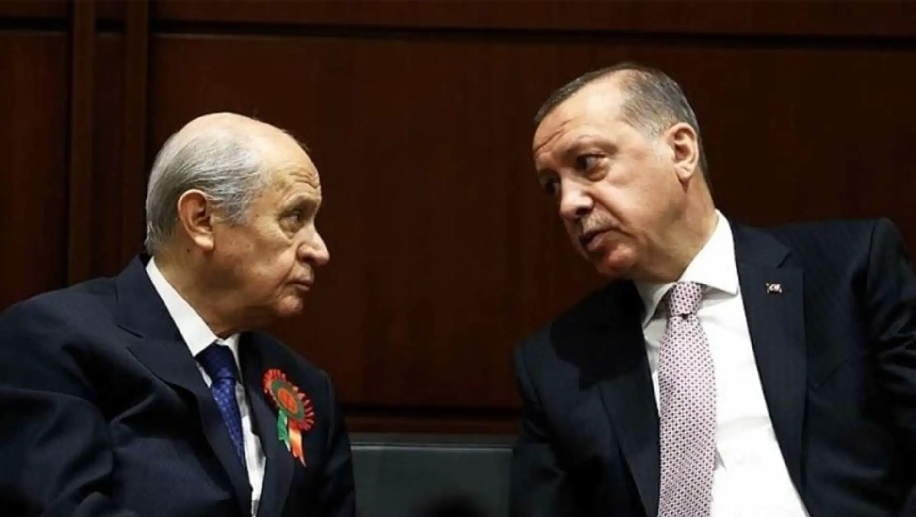 Two men looking at each other.