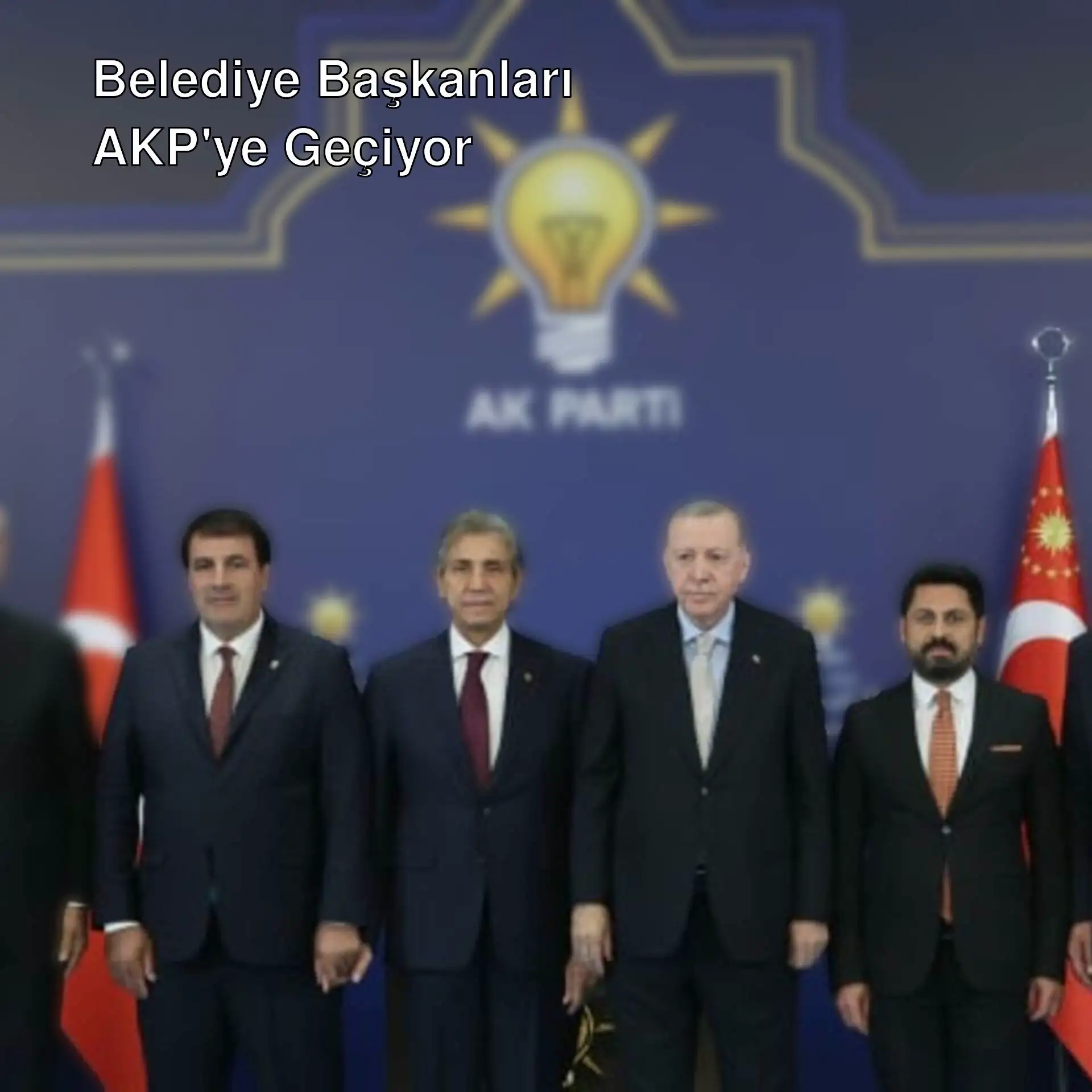 Bir grup adam takım elbiseyle poz veriyor.