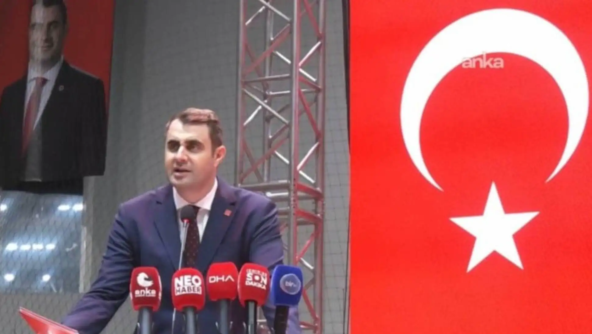 A man speaking into microphones.