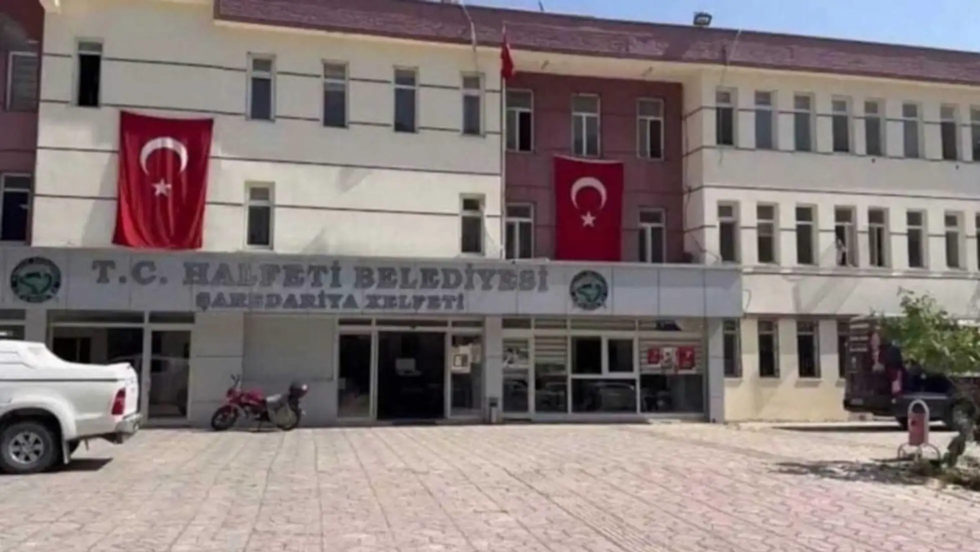 A building with a flag in front.