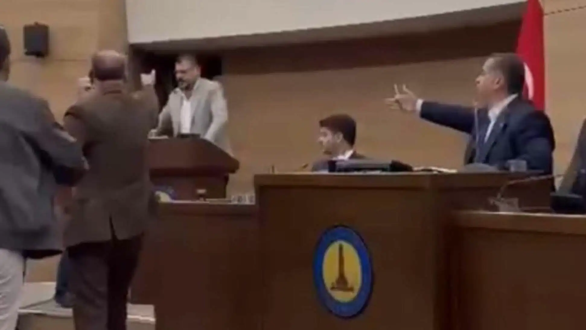 A man standing at a podium. A man standing at a podium.