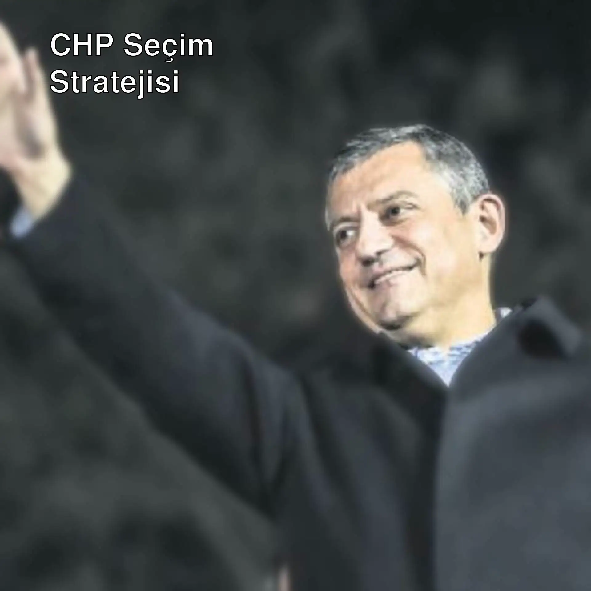 Bir adam elini kaldırarak selam veriyor.