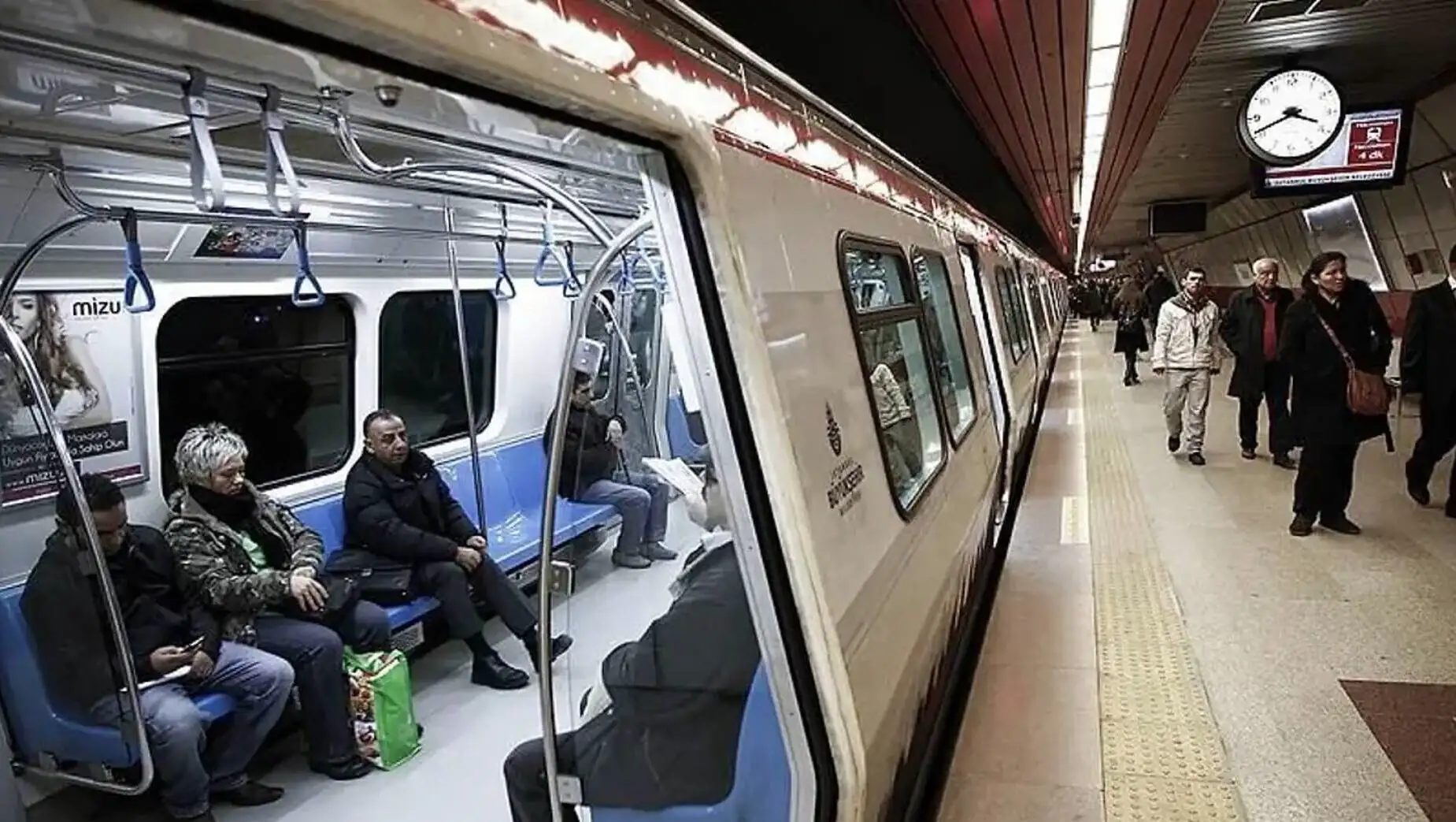 A train with people sitting on benches. A train with people sitting on benches.