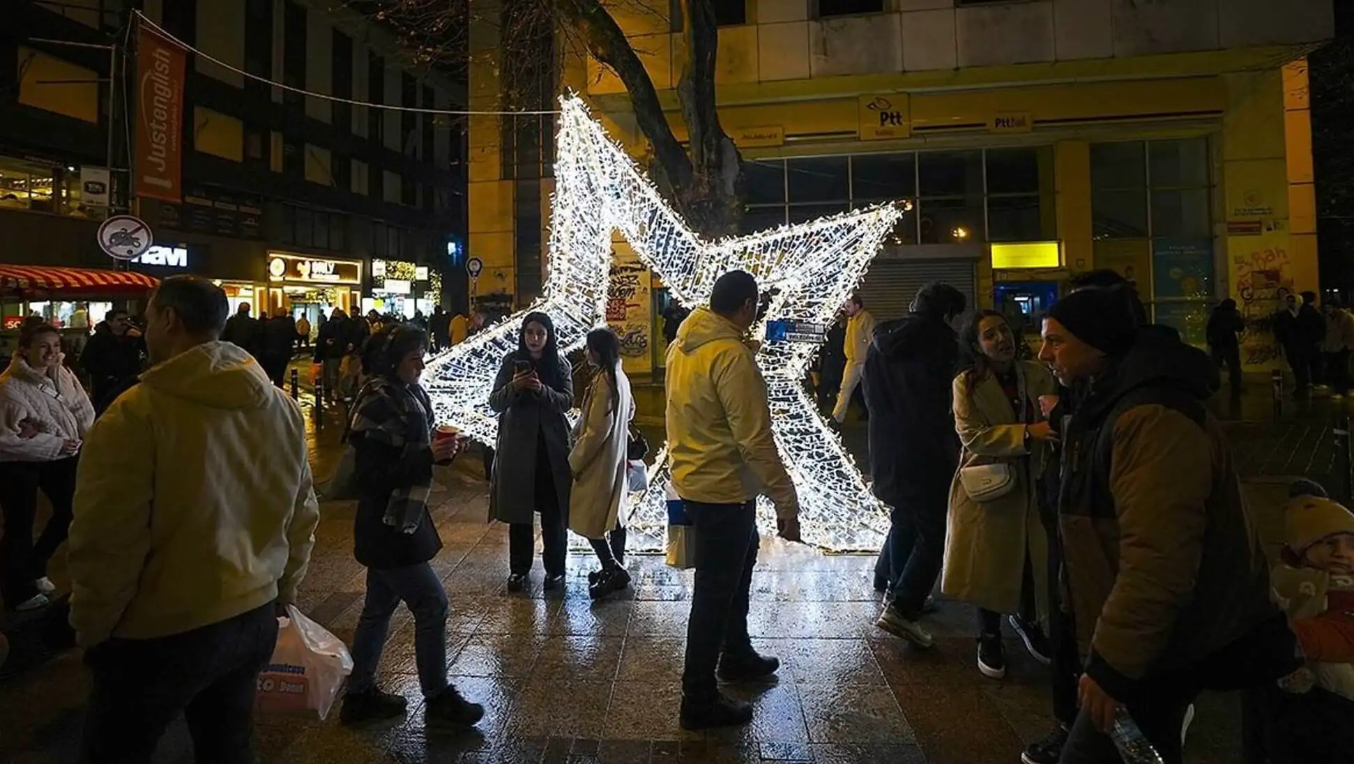 People standing around a star-shaped light. People standing around a star-shaped light.