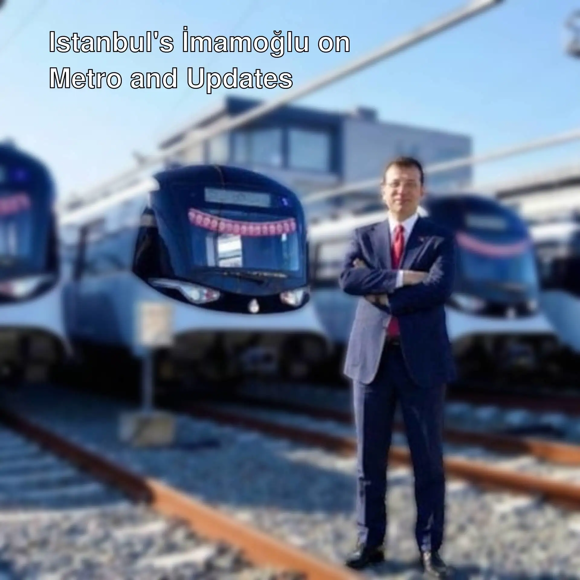 Ekrem İmamoğlu poses with new metro vehicles.